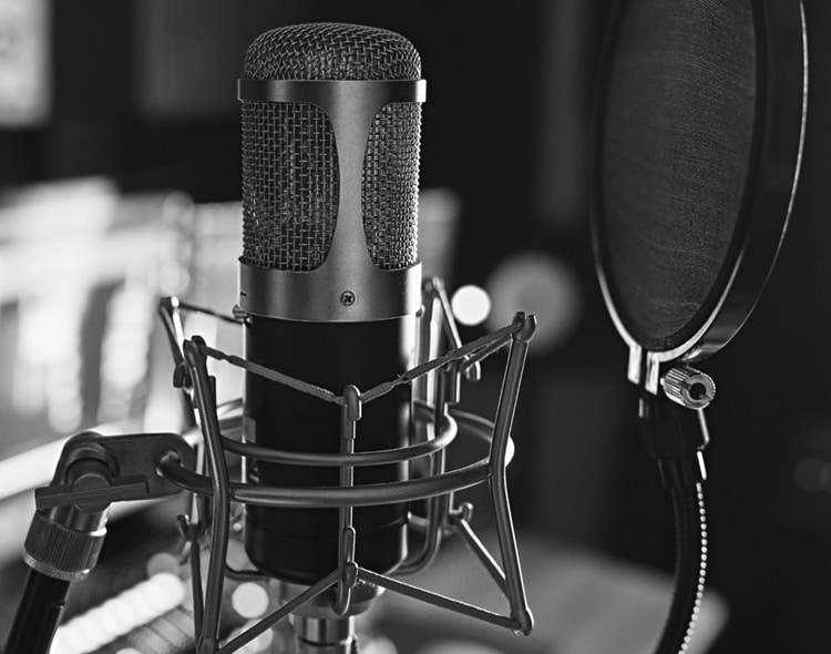A close up of a microphone in a professional media recording studio.