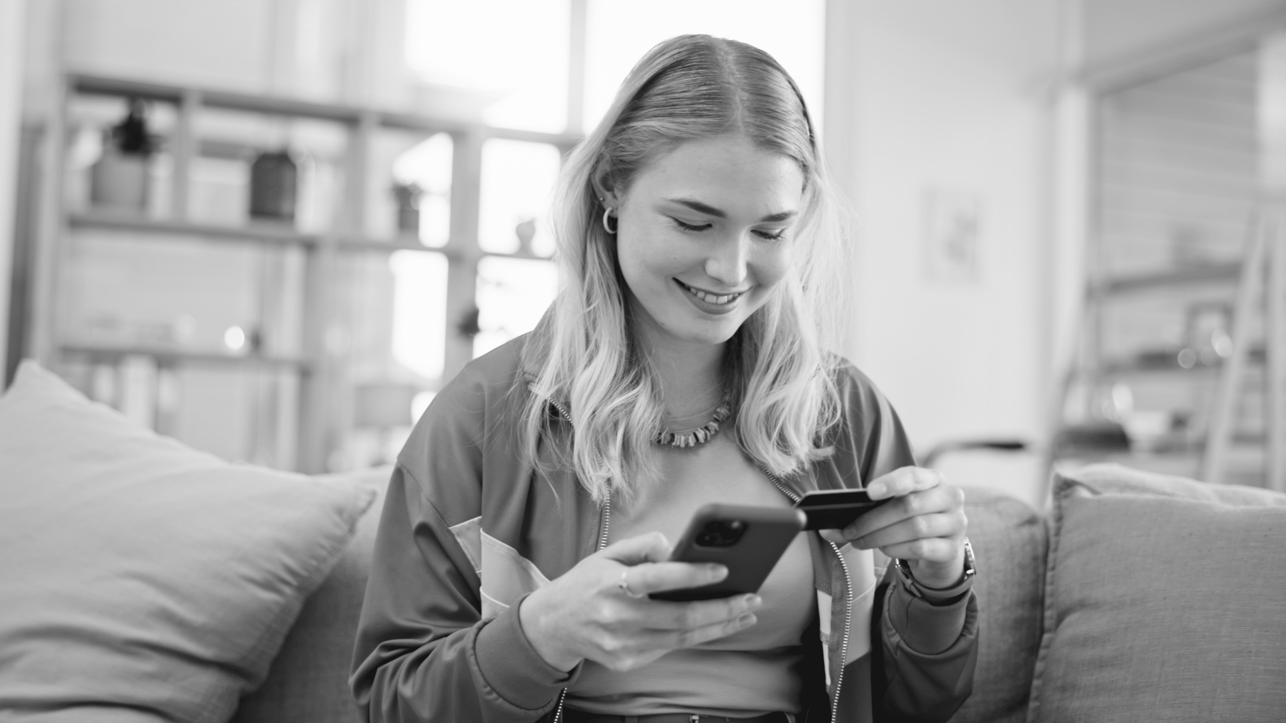 women making an online payment with her card via her phone